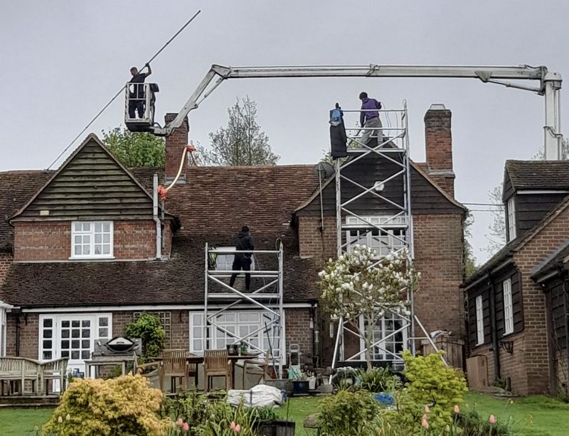 The Roof Moss Cleaners using cherry picker and scaffolding to clean roof safely and professionally in New Milton, Hampshire