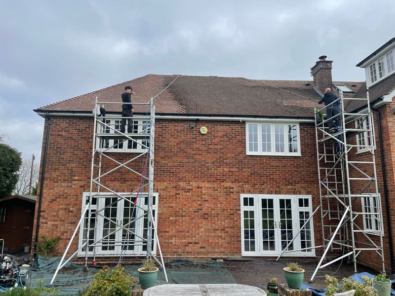 Roof cleaning carried out safely from scaffold towers by The Roof Moss Cleaners in New Milton